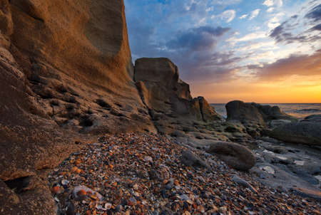 Russia. Dagestan. Dawn on the seashell-strewn rocky shore of the Caspian Sea near the city...