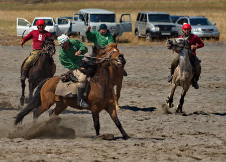 Kupchegen. Russia. May 14, 2021. Altai National Equestrian Game Kok-Boru. The moment of the fight of the players on horses for a sports equipment in the form of a goat carcass (ulah) weighing 35 kg.のeditorial素材