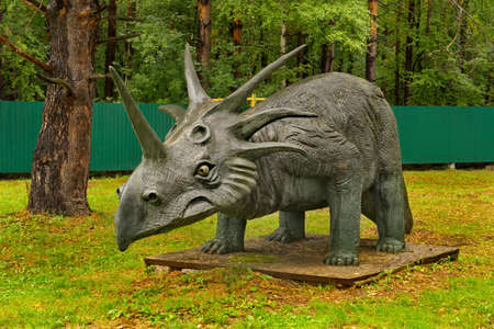 Novokuznetsk. Russia. August 15, 2020. Sculpture of a prehistoric dinosaur on the territory of the recreation camp "Lesnaya skazka", located in a pine forest.のeditorial素材