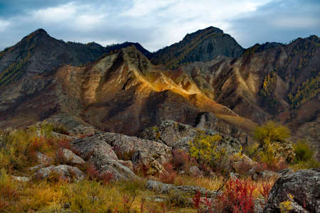 Russia. South Of Western Siberia, Altai Mountains. Illuminated by the evening sun, rocky mountains in the Katun River Valley near the village of Inya.の写真素材