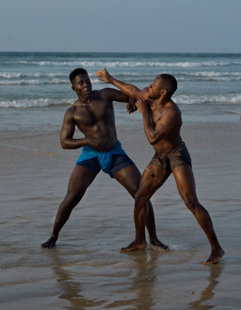 Dakar. Senegal. October 13, 2021. Two Senegalese wrestlers on the seashore participate in a Laamb wrestling match. Laamb is the only martial art where blows are struck with bare hands.のeditorial素材