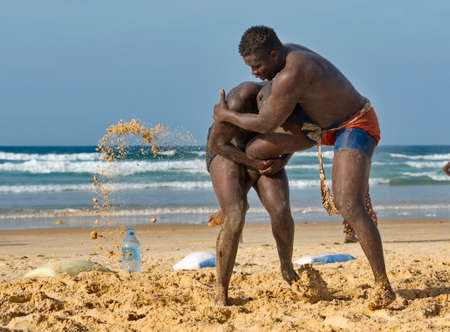 Dakar. Senegal. October 13, 2021. Two Senegalese wrestlers on the seashore participate in a Laamb wrestling match. Laamb is the only martial art where blows are struck with bare hands.のeditorial素材