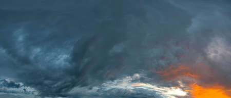 Russia. The South of Eastern Siberia. Gloomy sunset clouds in the evening summer sky over the...
