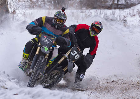 Novokuznetsk. Russia. February 19, 2022. Demonstration race on a snow-covered track of motorcycle racers at the festival of motor transport enthusiasts "Uni-Moto".のeditorial素材