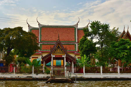 Bangkok. Thailand. December 02, 2016. Architecture of buildings in traditional Buddhist style on the banks of numerous channels of the capital Chao Phraya river.のeditorial素材