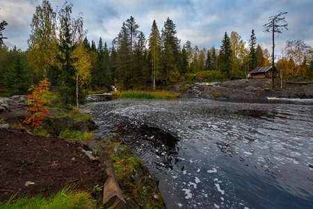 Russia. Republic of Karelia. Calm backwaters at the foot of flat waterfalls on the Tohmajoki River near the Ruskeala marble quarry.の写真素材