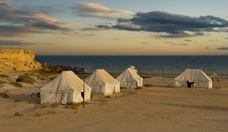 Arkess. Mauritania. October 08, 2021. A picturesque twilight evening in a tent camping on the Atlantic Ocean in the Banc National Nature Park.の写真素材