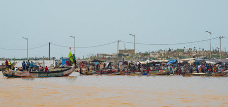 Saint-Louis. Senegal. October 10, 2021. View of the city pier on the Senegal River, with many wooden boats on which local fishermen go fishing both on the river and in the ocean.のeditorial素材