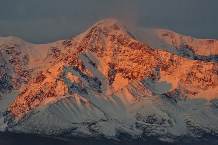 Russia. The South of Western Siberia, the Altai Mountains. The peaks of the North Chui mountain range illuminated by morning sunlight along the Chui tract near the village of Kuraiの写真素材