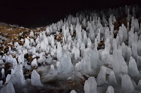 Russia. Kuril Islands. A cave with numerous ice stalagmites on the island of Iturup. Until 1945, a Japanese military hospital was located in these caves.の写真素材