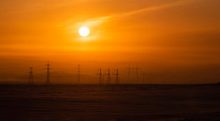 Russia. The South of Western Siberia. High-voltage metal structures against the background of a...