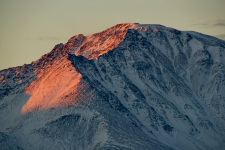 Russia. The South of Western Siberia, the Altai Mountains. Illuminated by the crimson morning light, the peaks of the North Chui Mountain Range along the Chui tract.の写真素材