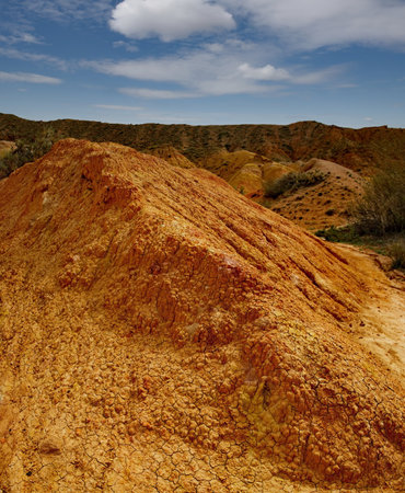 Northern Kyrgyzstan. Picturesque views of the famous Skazka Canyon (, the clay mountain peaks of which have bright colors from yellow to red-brown.の写真素材