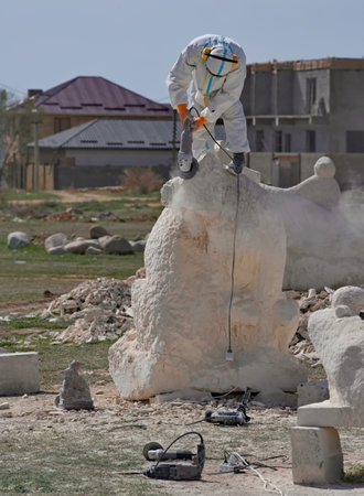 Cholpon-Ata, Kyrgyzstan. April 23, 2024. Sculptors use power tools to carve sculptures out of limestone for the festival in honor of the anniversary of the writer Chingiz Aitmatov.のeditorial素材