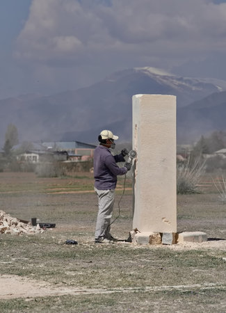 Cholpon-Ata, Kyrgyzstan. April 23, 2024. Sculptors use power tools to carve sculptures out of limestone for the festival in honor of the anniversary of the writer Chingiz Aitmatov.のeditorial素材