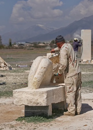 Cholpon-Ata, Kyrgyzstan. April 23, 2024. Sculptors use power tools to carve sculptures out of limestone for the festival in honor of the anniversary of the writer Chingiz Aitmatov.のeditorial素材
