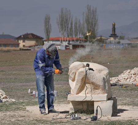 Cholpon-Ata, Kyrgyzstan. April 23, 2024. Sculptors use power tools to carve sculptures out of limestone for the festival in honor of the anniversary of the writer Chingiz Aitmatov.のeditorial素材