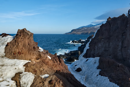 Russia. Far East, Kuril Islands. Very hard and sharp basalt rocks along the coast of the Sea of Okhotsk on the island of Iturup.の写真素材