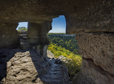 A view from inside the dilapidated stone room of the famous cave city of Mangup-Kale of the 5th...