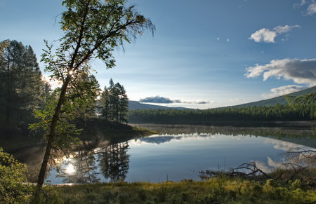 Russia, Western Buryatia. Early morning on the deserted taiga lake Guzen-Nur, hidden from prying eyes, on the left bank of the Tisa River.の写真素材