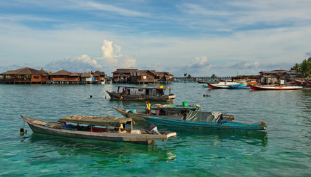 Semporna. Malaysia. November 30, 2018. In the early warm morning, long fishing boats on the reef...