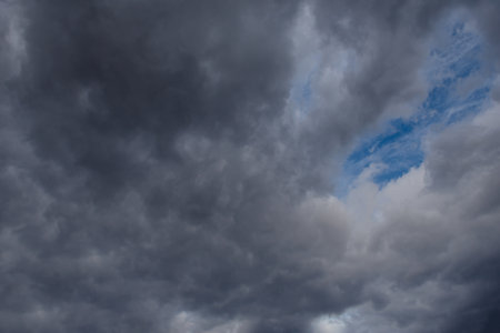 Central Kazakhstan. View of the glowy dramatic sunset sky with dark clouds.