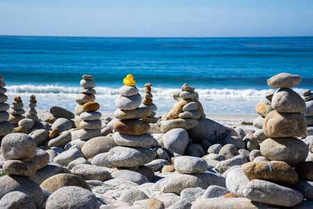 Rubber Duck on top of stacked stonesの写真素材
