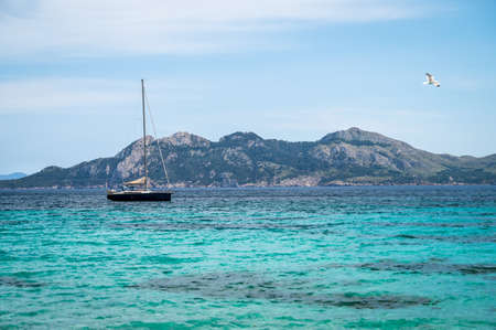 Single Boat on calm sea no cloudsの写真素材