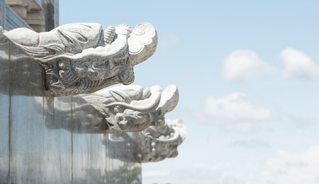 Dragon-shaped stones that adorn the walls of the walk way in a Chinese temple.の写真素材