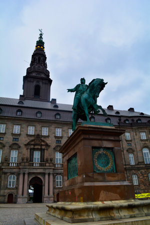 Copenhagen, Denmark - July 2021: Equestrian statue of Frederick VII in front of the Christiansborg Palace on a gloomy day.のeditorial素材