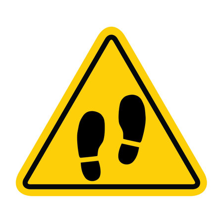 Vector illustration of a warning sign with footprints on a yellow background.のイラスト素材
