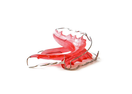 Red dental retainer orthodontia isolated on white backgroundの写真素材