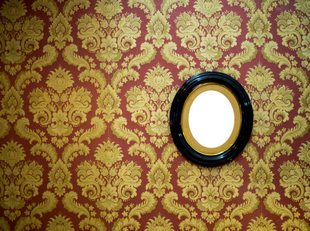 Oval wall picture frame on classic wallpaper with copy spaceの写真素材