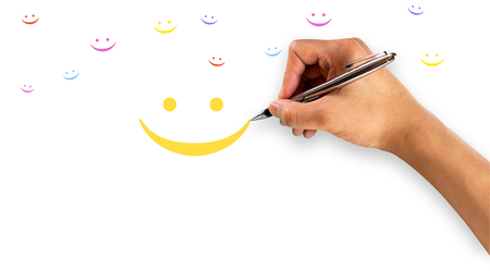 Smiley face with hand writing and small smiley faces in many colorsの写真素材