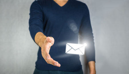 Mail sign light effect, catching by man handの写真素材