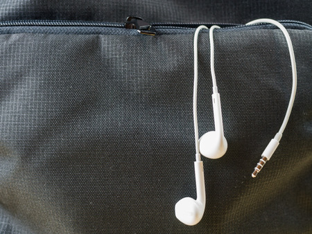 Earphone, in ear headphone in front pocket, music and lifestyleの写真素材