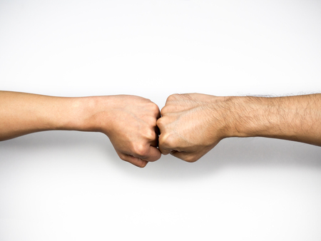 Fist bump on white background, close upの写真素材