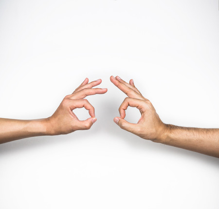 Ok, two hands agree gestures on white backgroundの写真素材