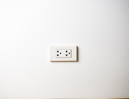 White socket 220 volts on white wall, unpluggedの写真素材