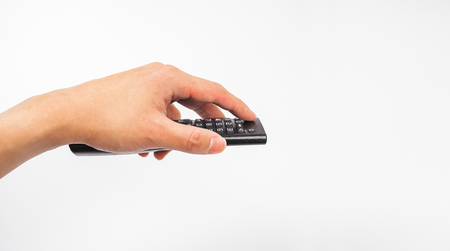 Remote tv in hand holding, switching channelsの写真素材