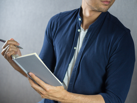 Man writing on note book close upの写真素材