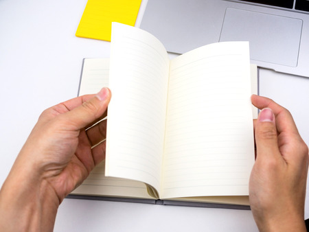 Flip and open notebook on deskの写真素材