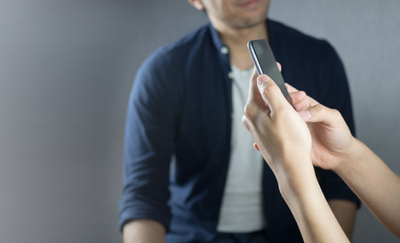 Using phone while other talkingの写真素材