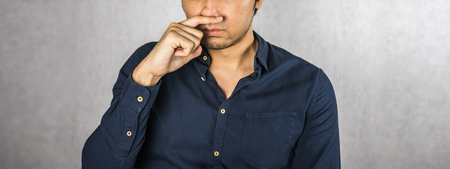 Man making hand cover mouth expressionの写真素材