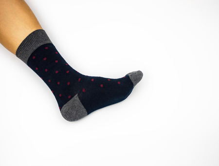 Leg wearing sock on side on white background