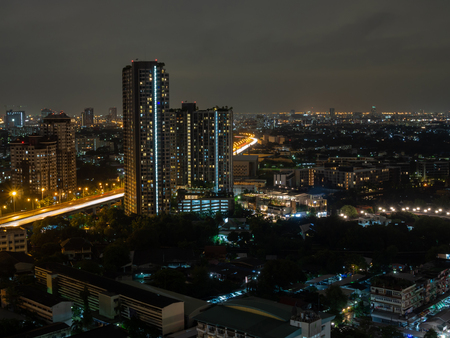 Buildings and highway road in city at nightの写真素材