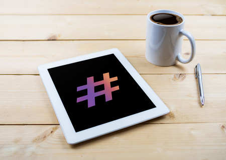 Hashtag symbol on tablet on work deskの写真素材