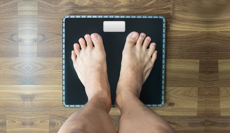 Feet on Weighing scale, person's looking down viewの写真素材
