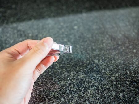 Using nail clipper to trim nails close upの写真素材