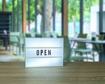 Open text light box sign in blurry restaurant viewの写真素材